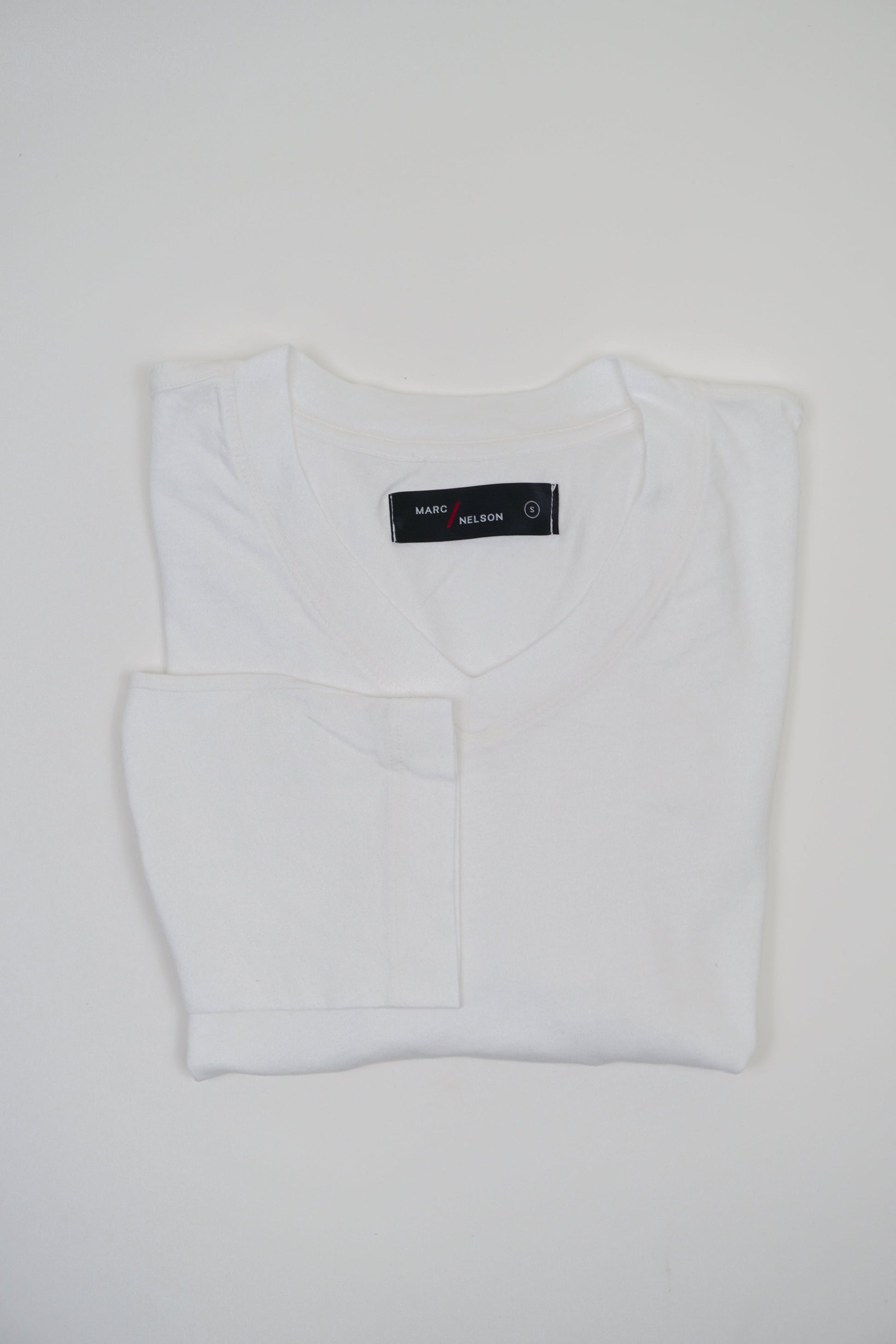 Marc Nelson men's white t-shirt, folded.