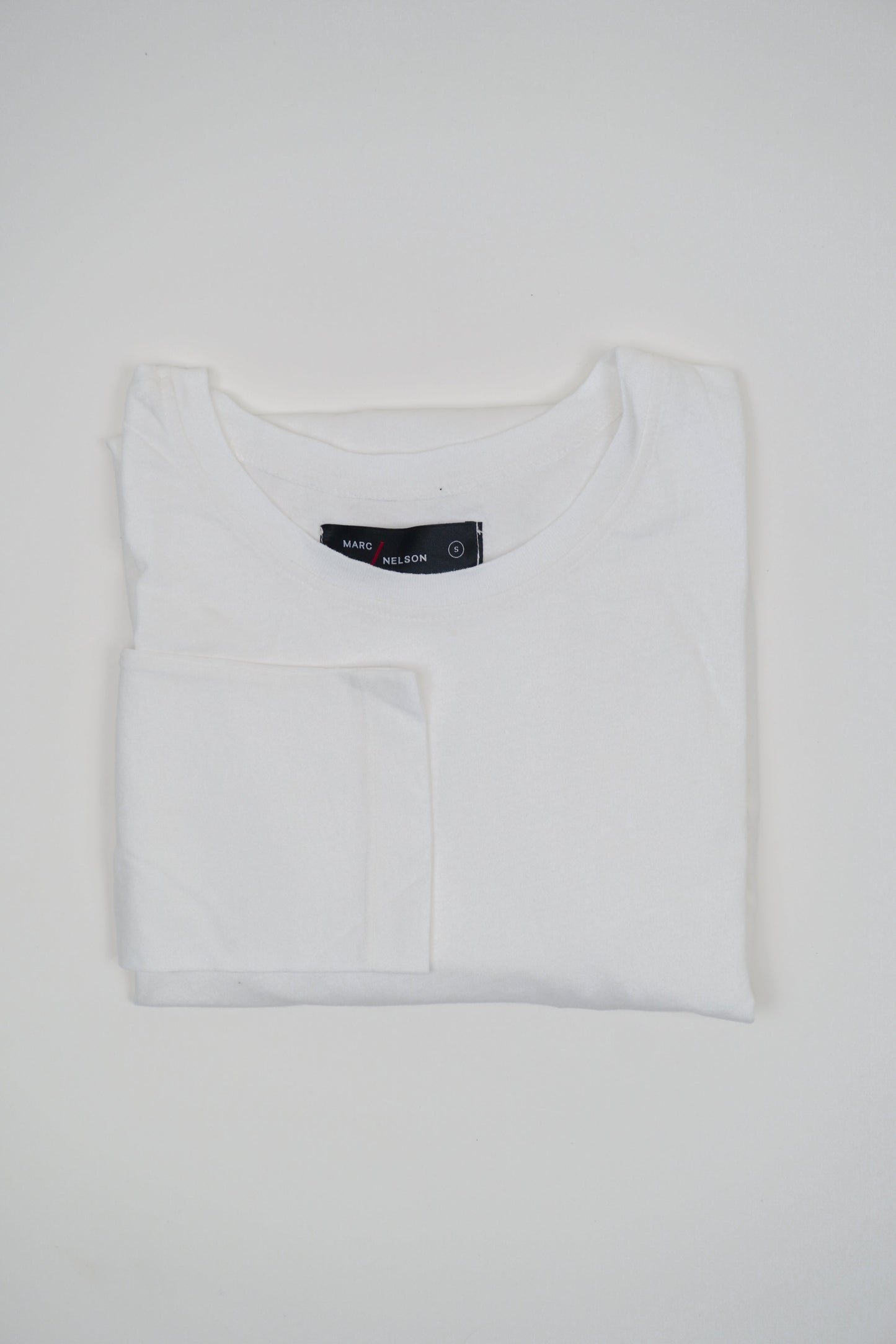 Marc Nelson men's white t-shirt, folded.