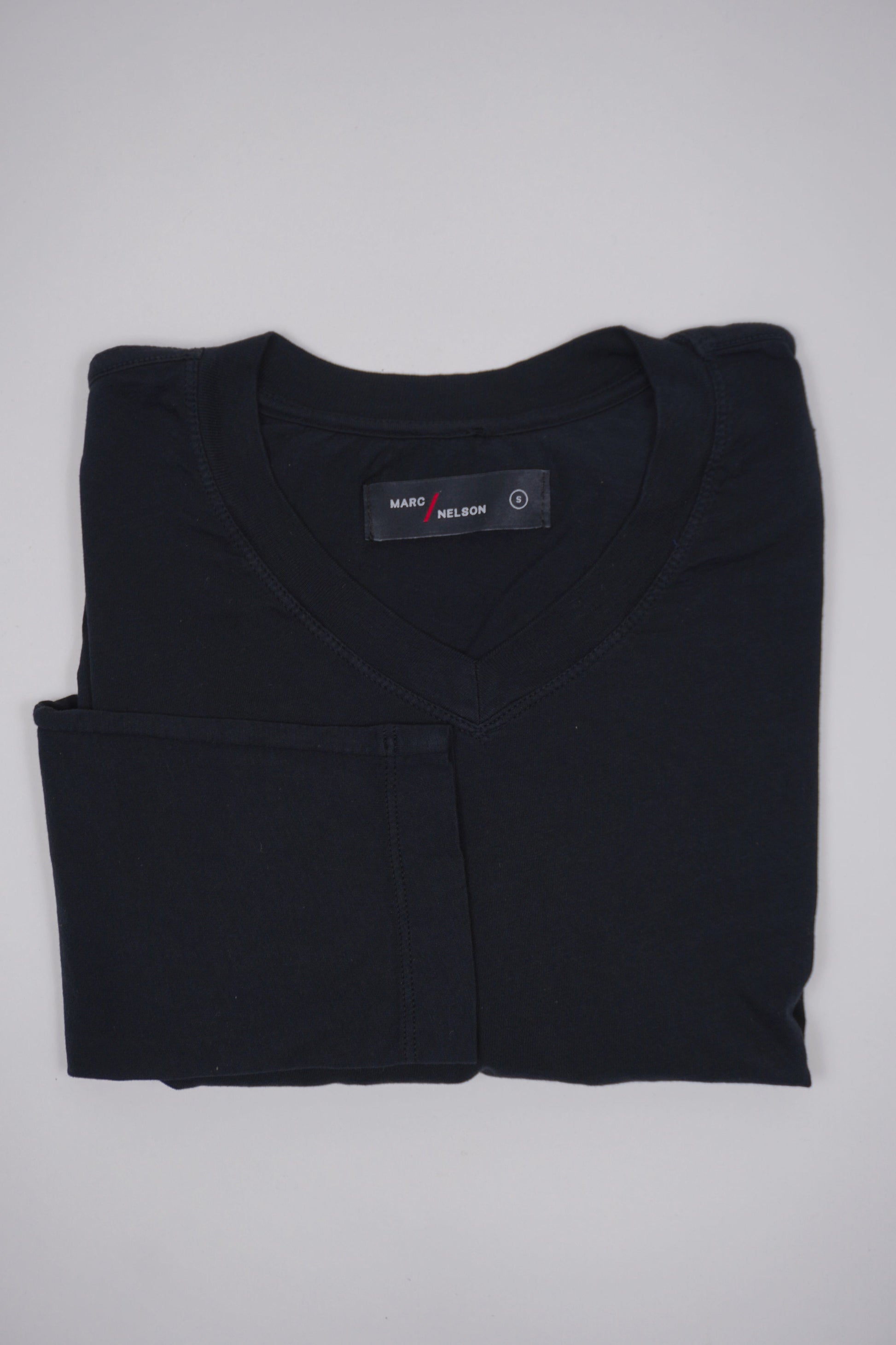 Marc Nelson men's black t-shirt, folded.