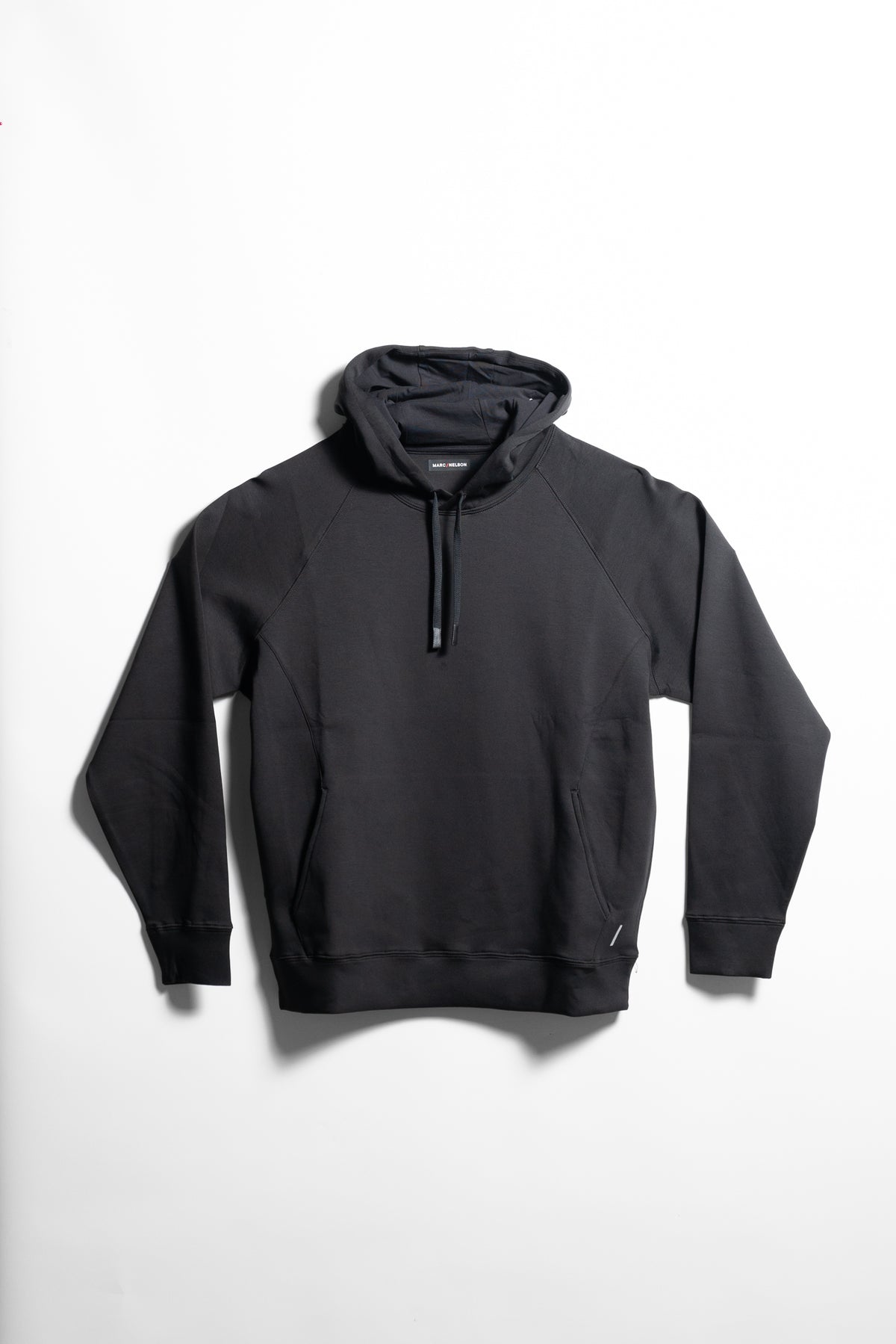 A plain black hooded sweatshirt with a front pocket and long sleeves, laid flat on a white background.