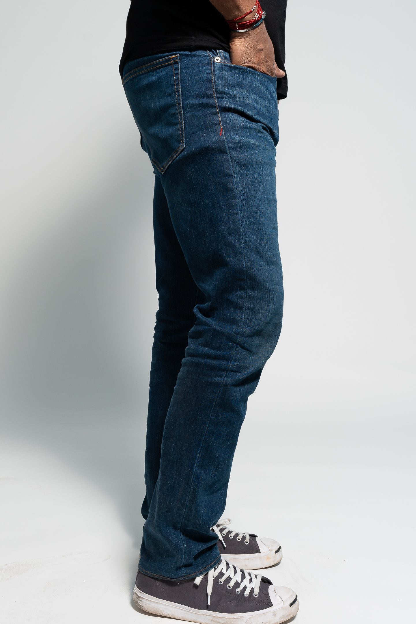 Photo of model wearing Nelson Medium Wash Denim on white background with hips pointing towards the camera.