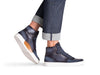 Image of a man wearing navy blue high top sneakers and Marc Nelson selvedge denim.