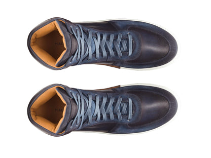 A pair of blue high-top sneakers on a white background. The sneakers have a lace-up closure and a round toe. They are made of leather and have a white sole, top view.