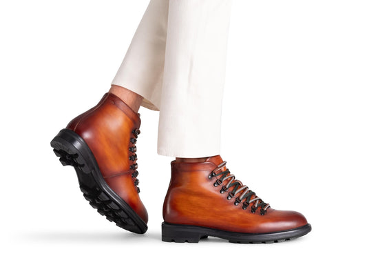 Man wearing brown men's Magnanni Montana hiking boots on a white background.