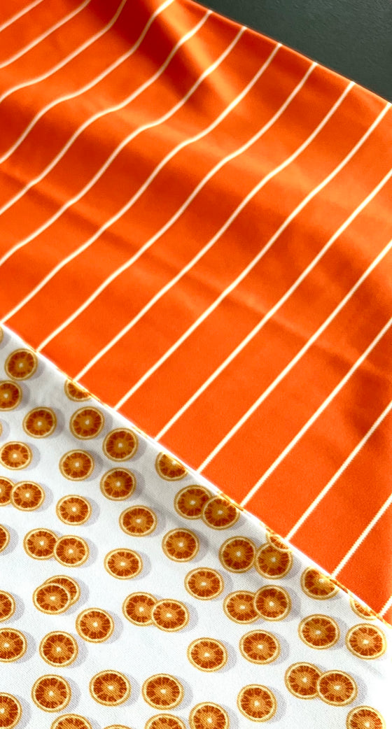 Close up photo of Golf Polo oranges and orange and white stripe patterns.