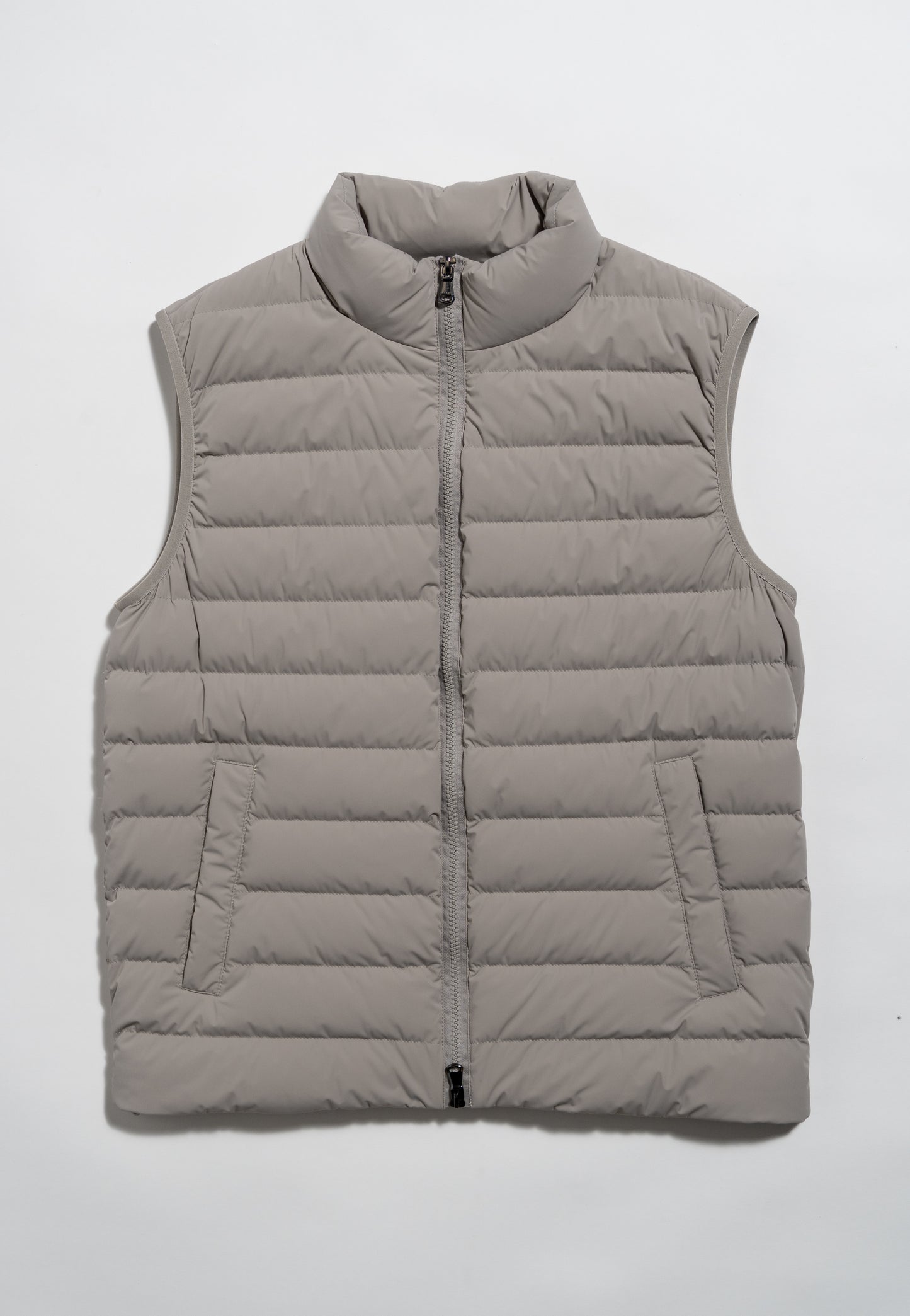 A light gray, sleeveless puffer vest with horizontal quilting, a zip-up front, and two side pockets, laid flat on a white background.