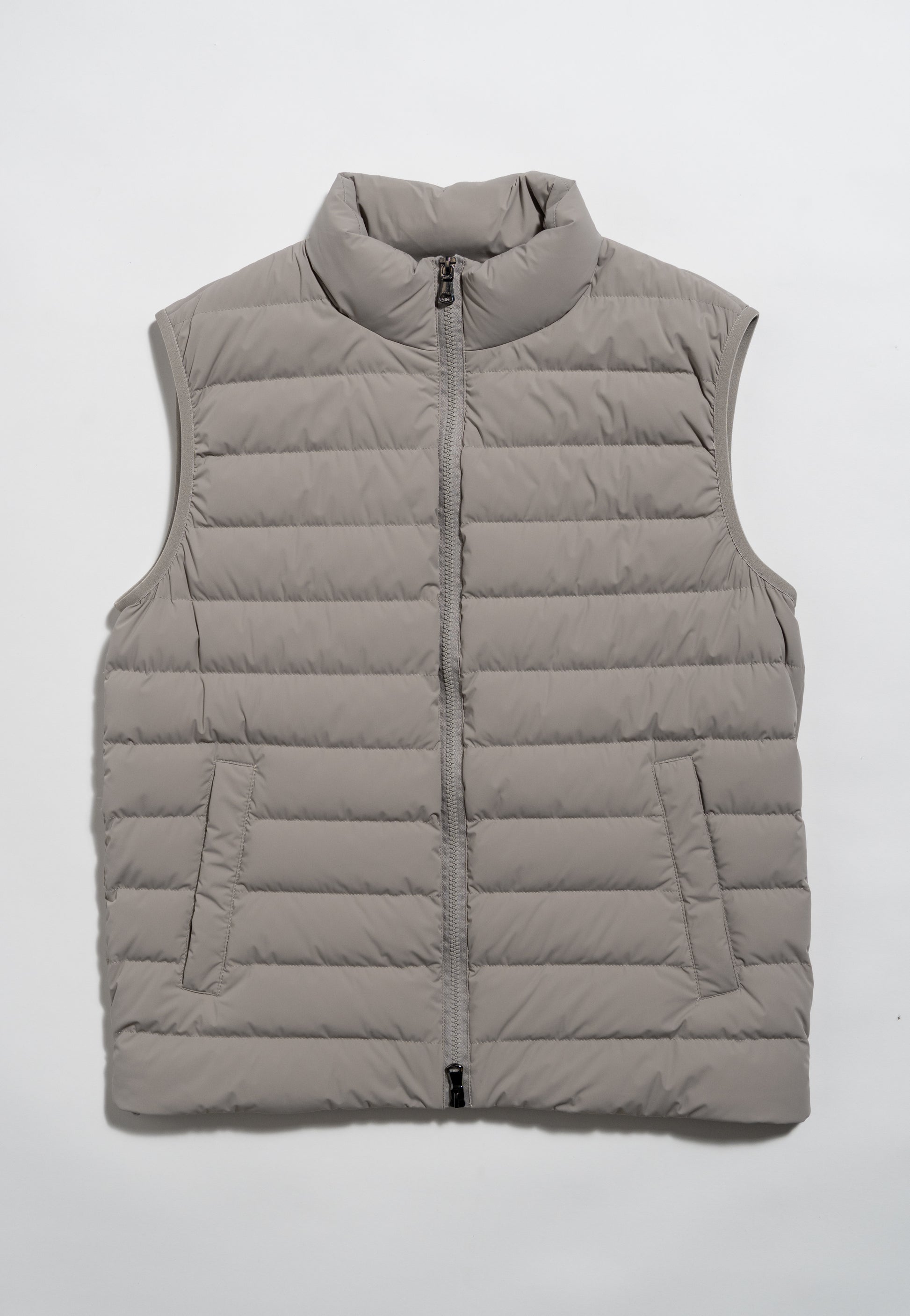 A light gray, sleeveless puffer vest with horizontal quilting, a zip-up front, and two side pockets, laid flat on a white background.