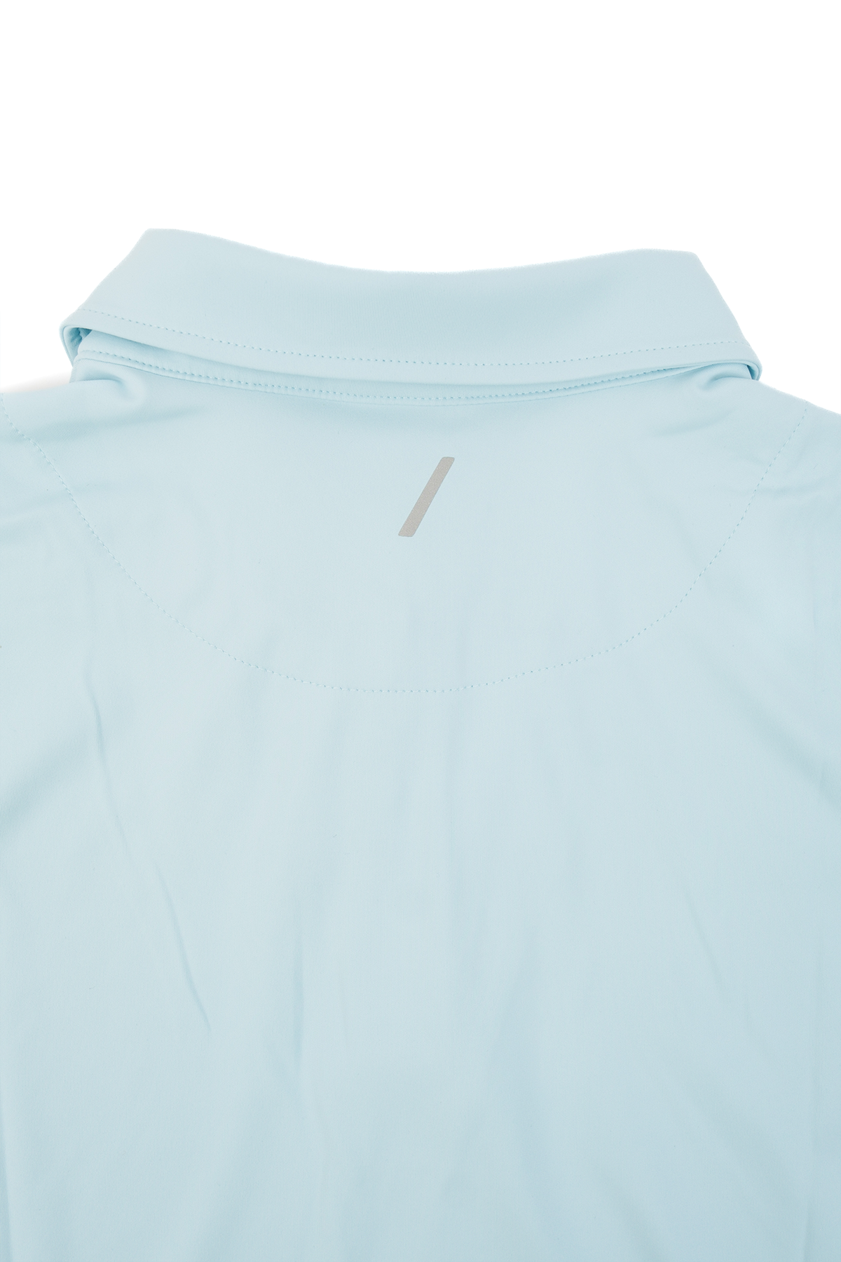 Backside close up of Light blue golf polo laid flat on a white background.