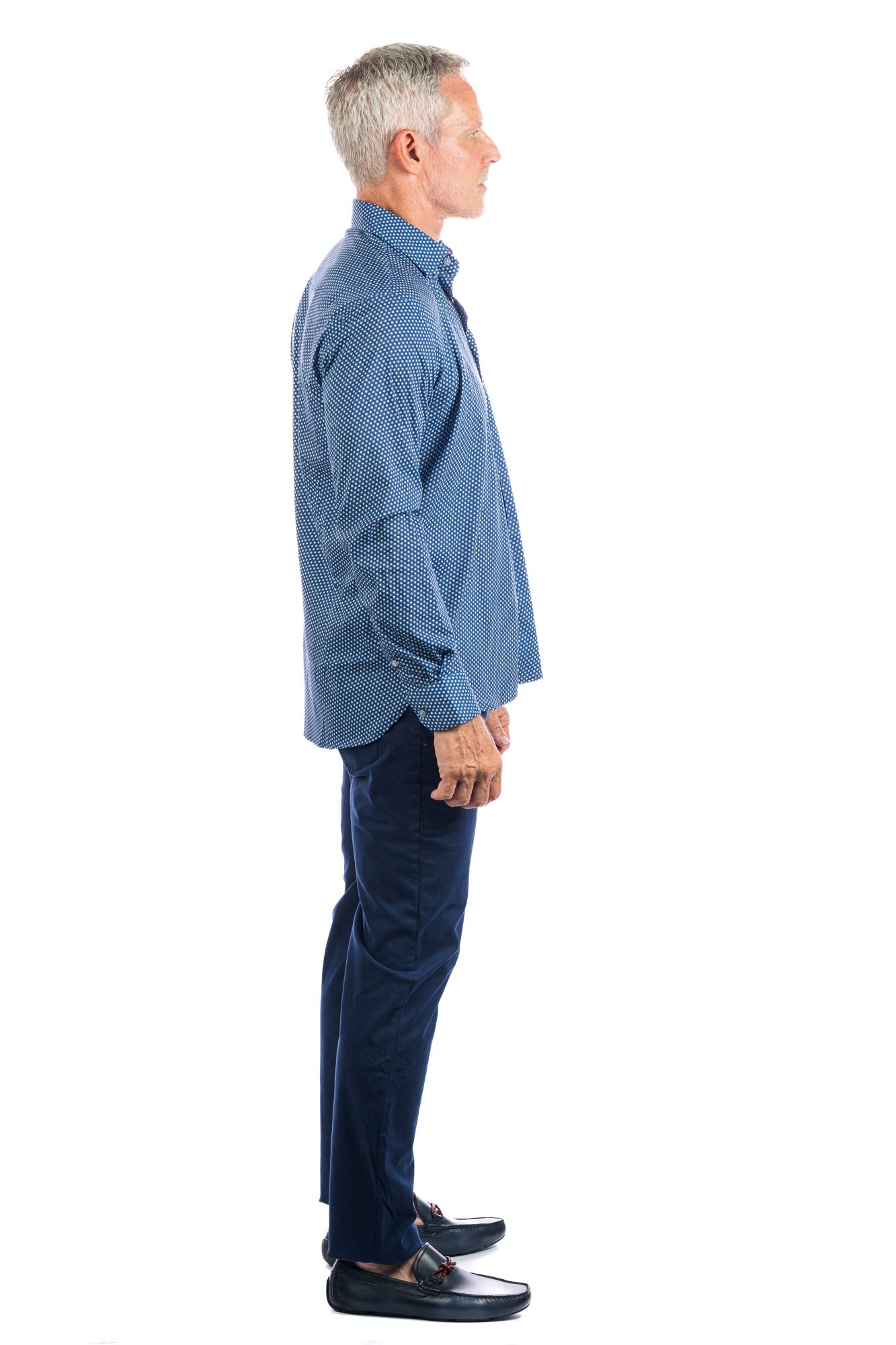 Side profile photo of model wearing the george navy pants on a white background and looking away from the camera.
