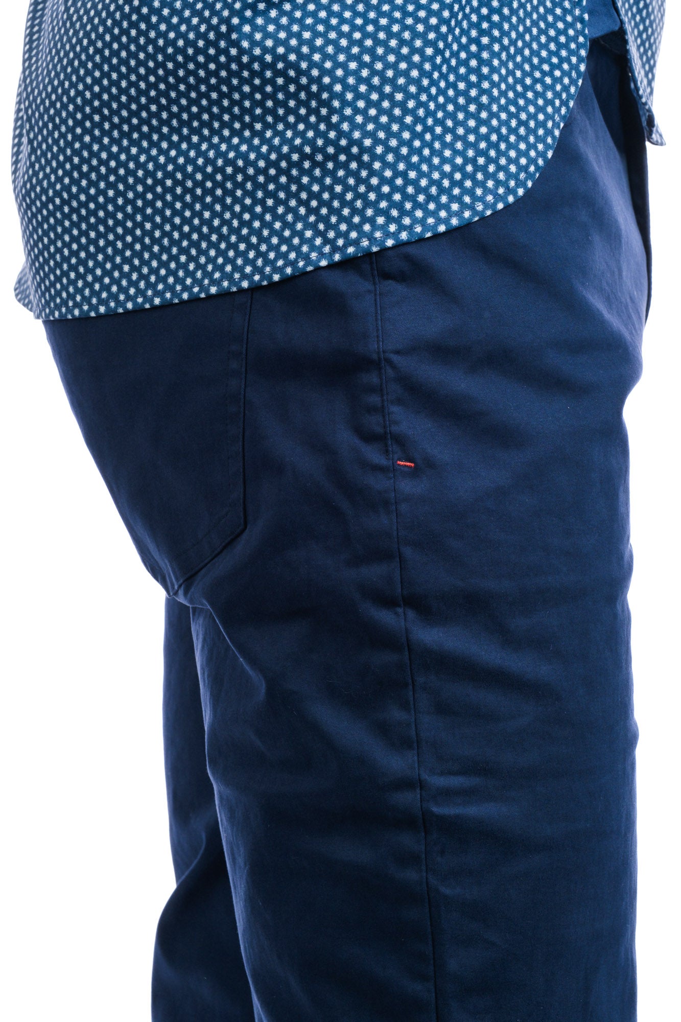 Close up side view of man wearing navy pants.