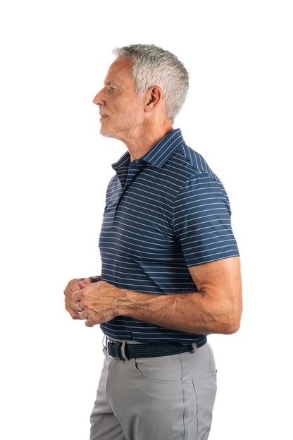 Side profile photo of model wearing navy polo with white stripes on a white background.