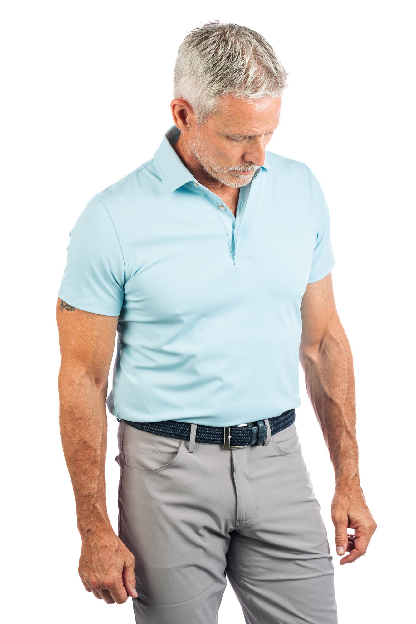 Waist up photo of light blue golf polo on white background on a model.