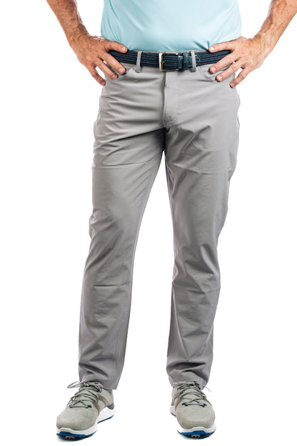 Half body shot of our Concrete golf pants on a model with his hands on his hips. 