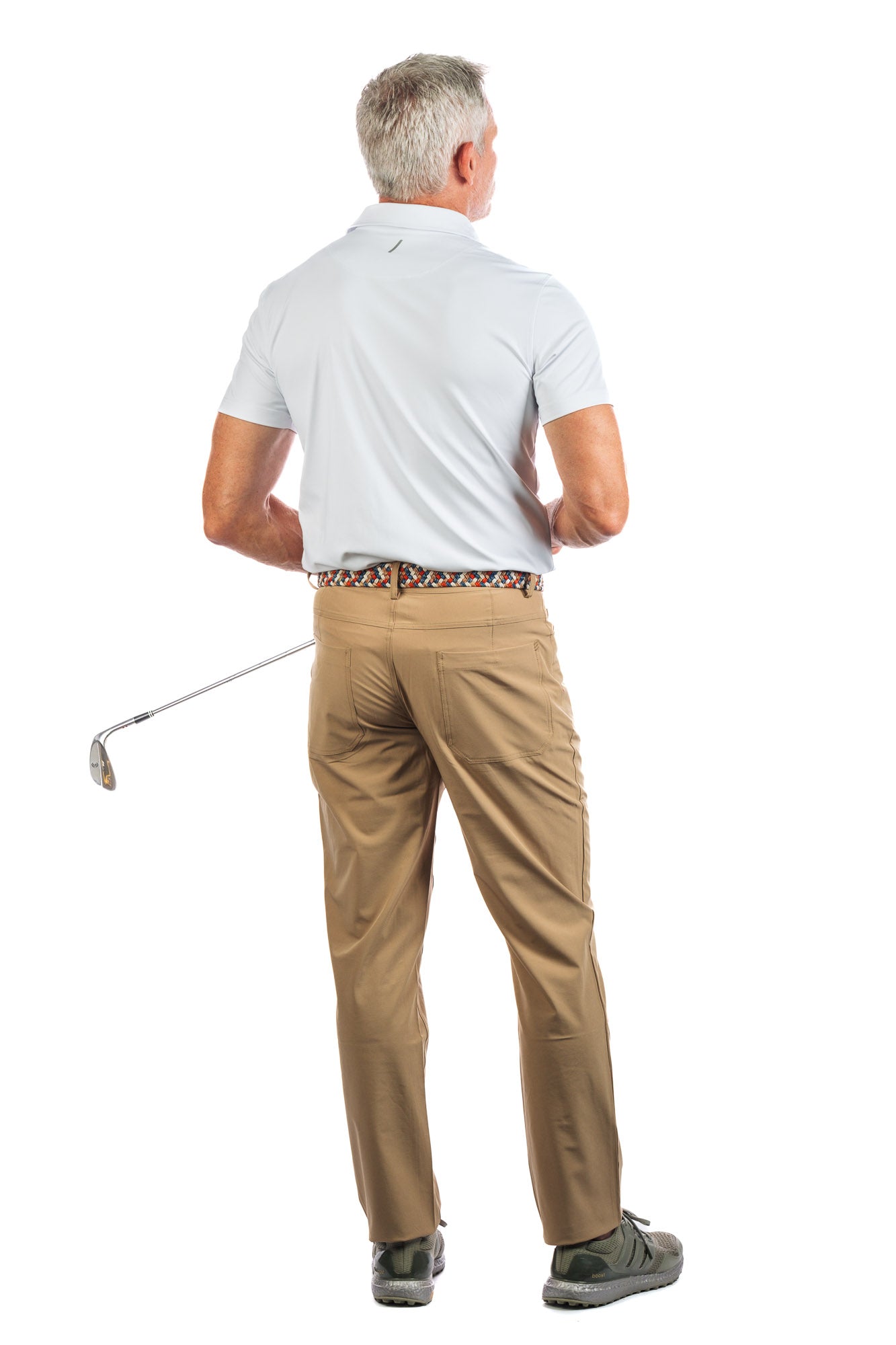 Photo of a model wearing our White Golf Polo on a White Background looking to the right. 