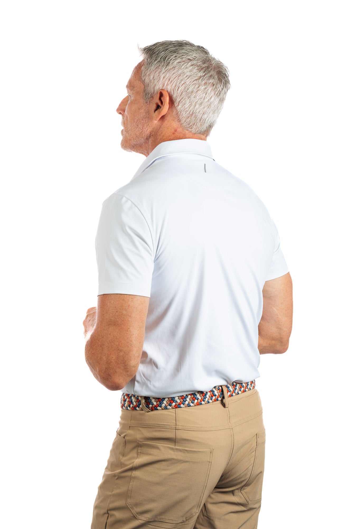 Photo of a model wearing our White Golf Polo on a White Background with his backside facing us. 
