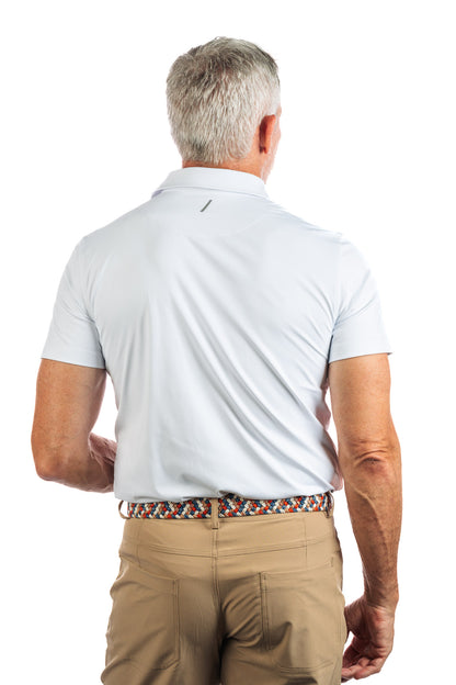 Photo of a model wearing our White Golf Polo on a White Background full backwards to the camera. 