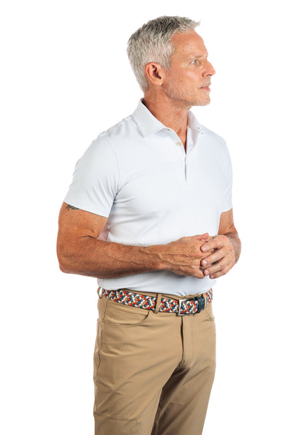Photo of a model wearing our White Golf Polo on a White Background with the model facing the right. 