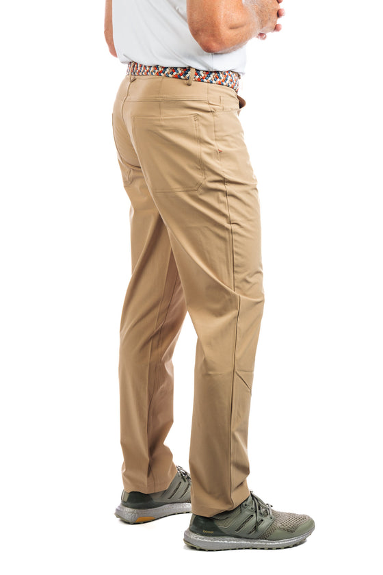 Side view of a man wearing Marc Nelson Golf Pant in Sand.