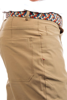  Close up side view of a man wearing Marc Nelson Golf Pant in Sand.