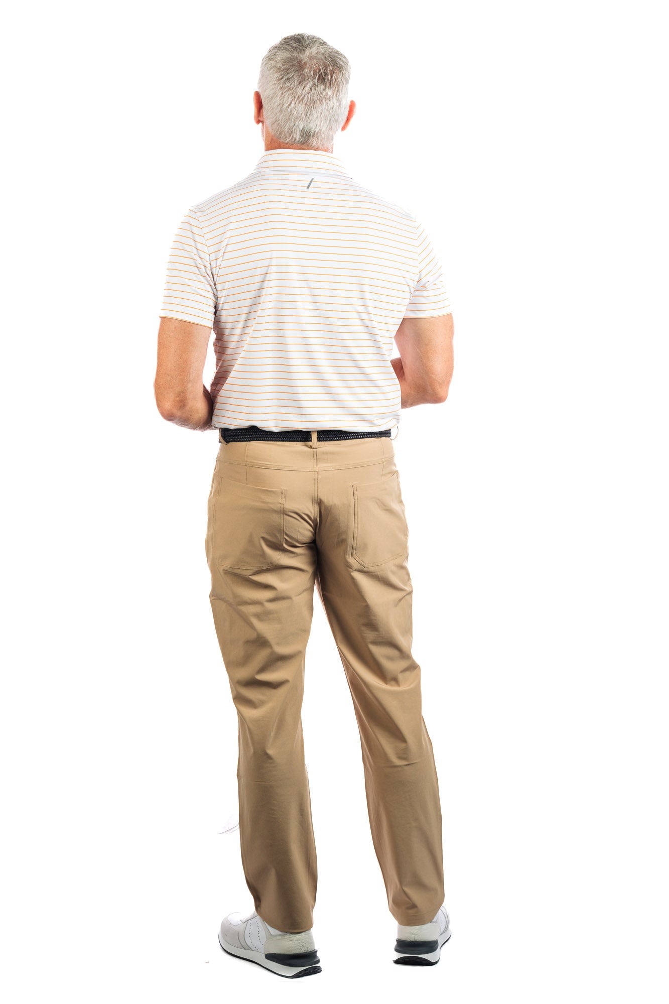 Backside photo of model wearing the Orange striped golf polo on a white background. 