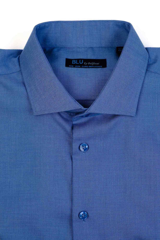 Blue dress shirt folded on a white background, close up.