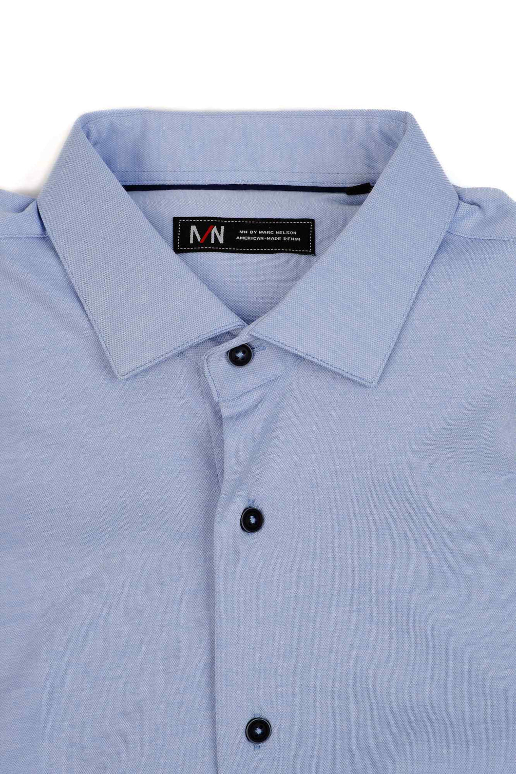 Light blue Marc Nelson knit dress shirt folded on a white background.