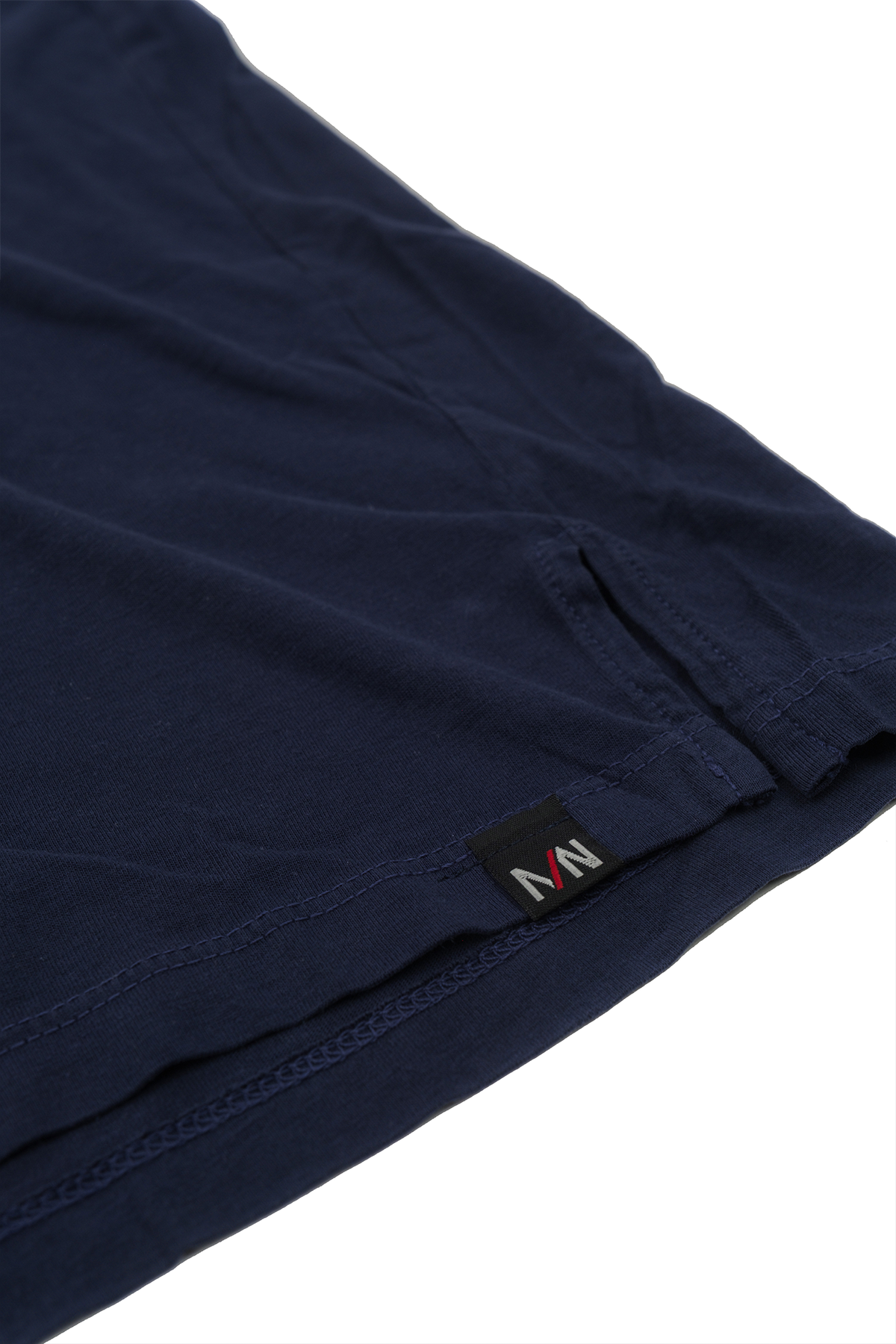Close up of navy v-neck t-shirt laid flat on a white background.
