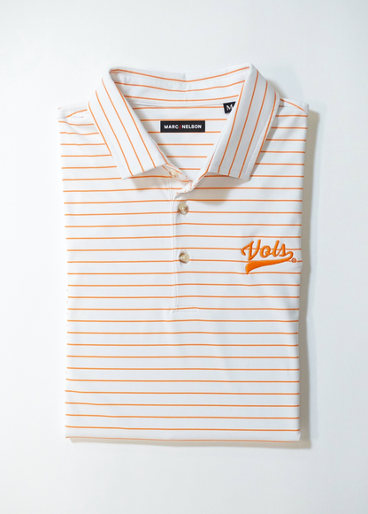 A neatly folded white polo shirt with thin orange horizontal stripes, a collar, and Vols embroidered in orange on the left chest. The shirt tag reads Marc Nelson.