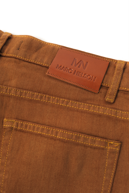 Showing the backside details on the whiskey washed denim on a white background. 