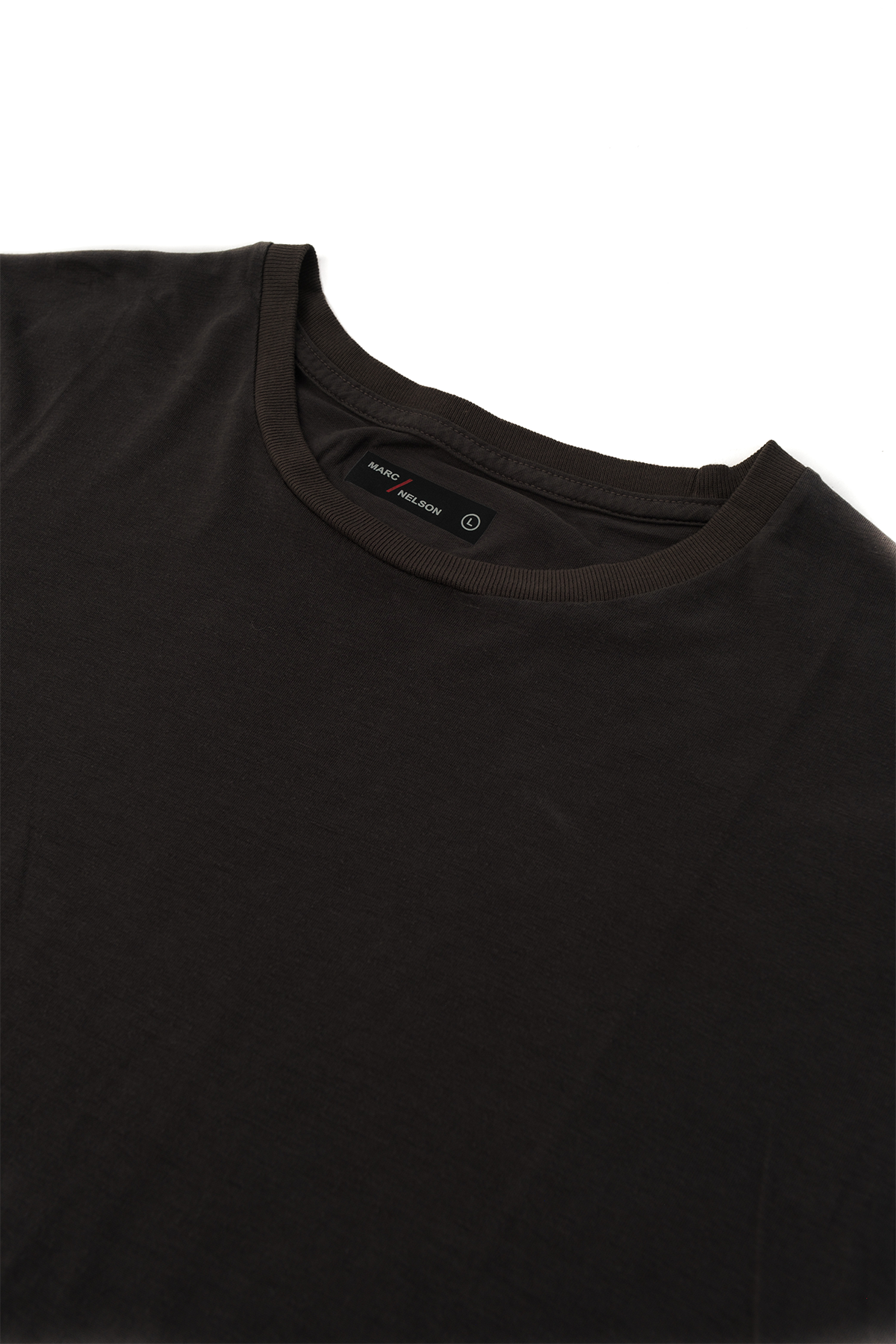 Close up of a black crew neck t-shirt laid out on a white background.