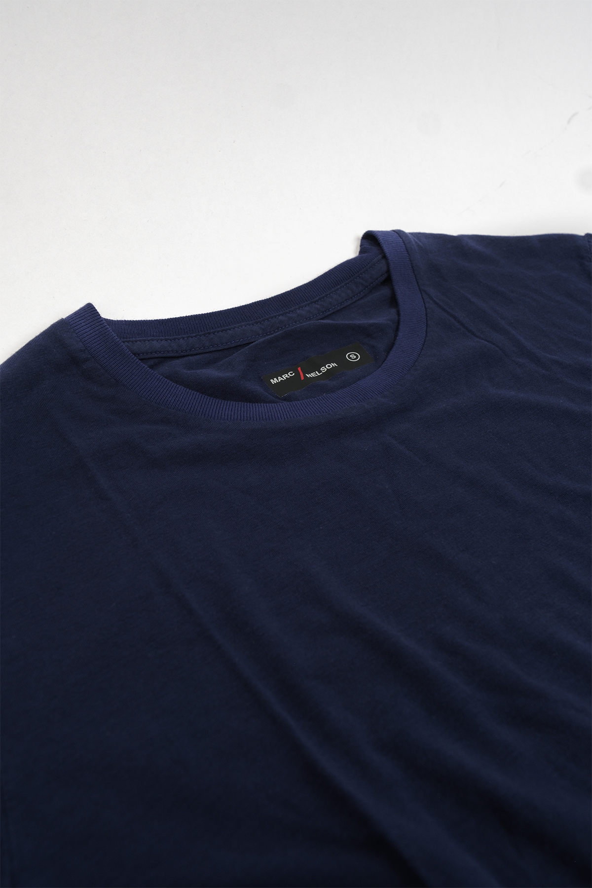 Navy crew neck t-shirt laid flat on a white background.