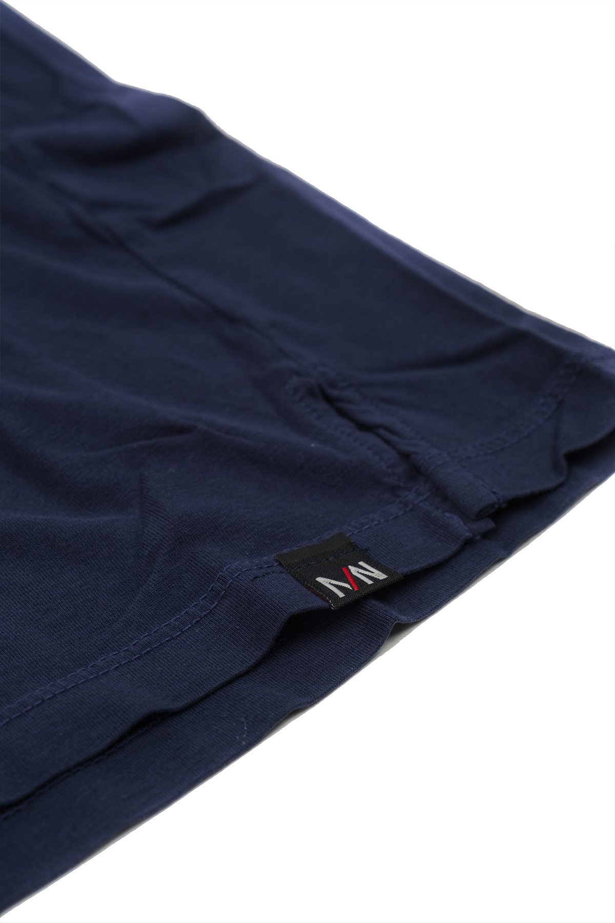 Close up shot of tag on Navy crew neck t-shirt folded on a white background.