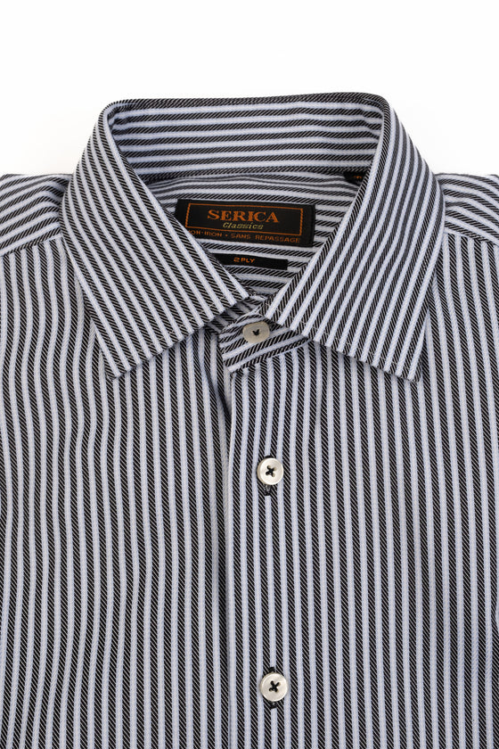 Striped dress shirt folded on a white background, close up shot.