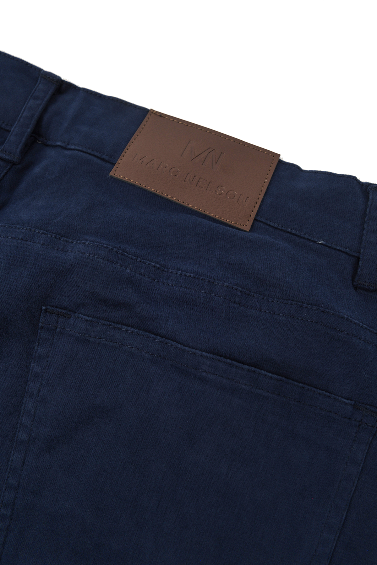 Close up photo of the backside of the George Navy Pants focusing on the details of the leather tab and the back pocket. 
