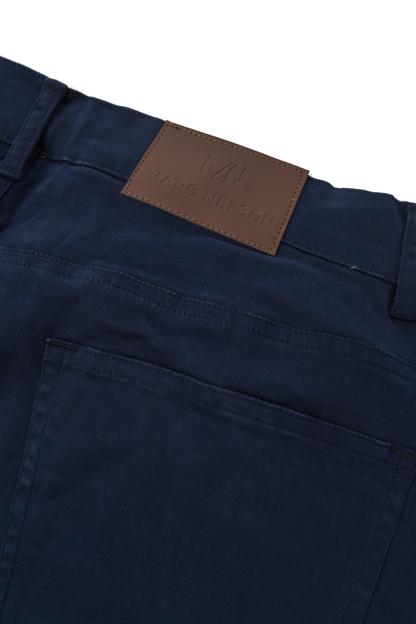 Close up photo of the backside of the George Navy Pants focusing on the details of the leather tab and the back pocket. 