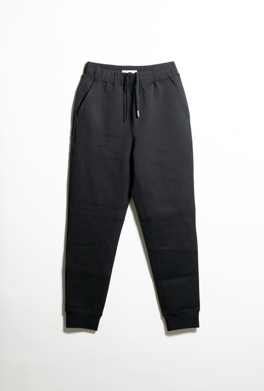 Black jogger sweatpants with an elastic waistband, drawstring, side pockets, and ribbed cuffs, laid flat on a white background.