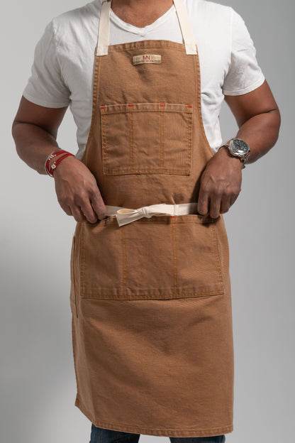 Canvas apron on model on a white background. 