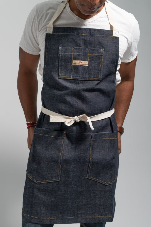 Photo of a model wearing the Common Apron in Indigo. 