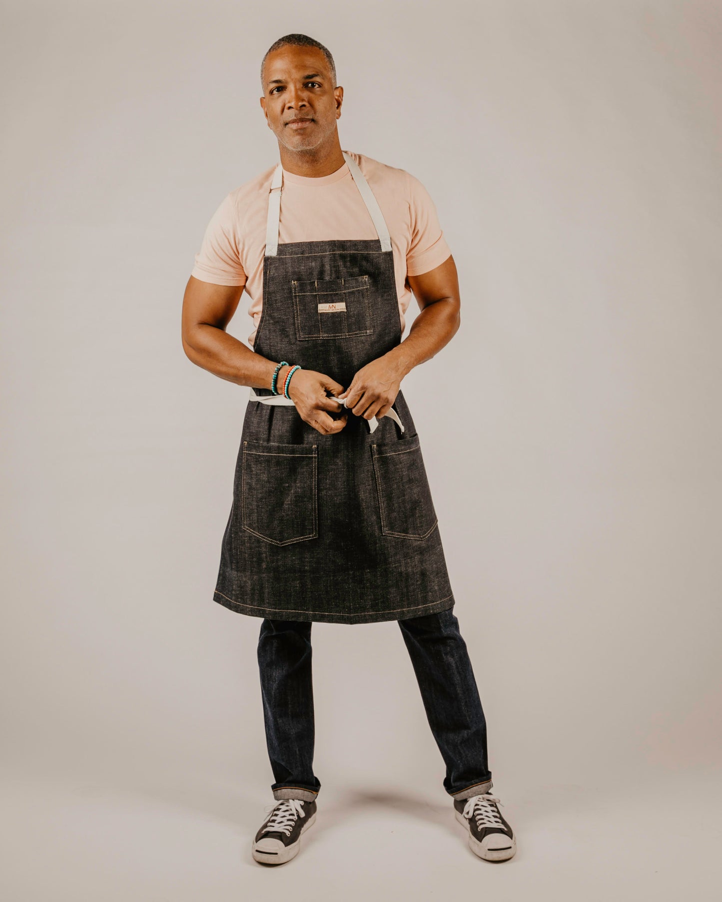 Full length photo of a model wearing the Common Apron in Indigo.